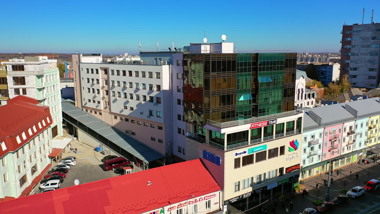 In the downtown of the modern city on sunny day. Business centre with contemporary buildings. Residential area at backdrop. Top view.