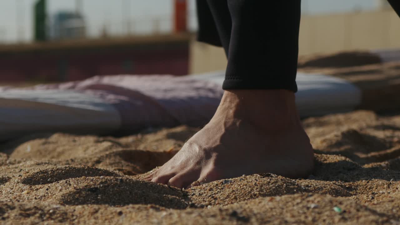 Surfer man walking to the beach at sunset preparing for surfing training and search for waves in Barcelona, spain, water, ocean exercise in sea with board, athletic male holiday or travel in vacation