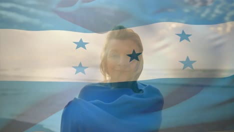 Animation-of-flag-of-honduras-over-happy-senior-caucasian-woman-on-beach