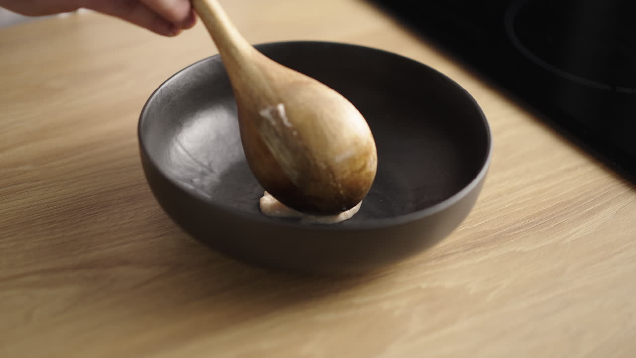 Preparing food with a wooden spoon in a bowl