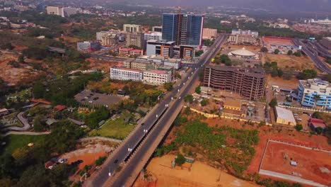 beautiful aerial of a long highway running towards a distant city in nigeria, africa