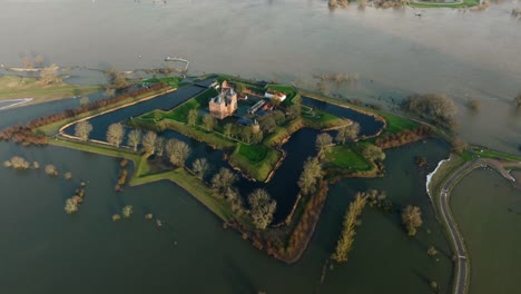 iconic loevestein castle in poederoijen surrounded by floodwaters