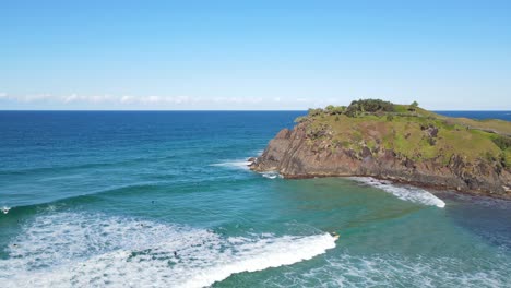 Surfers-Riding-The-Ocean-Waves-At-The-Blue-Beach-of-Norries-Cove-In-NSW,-Australia