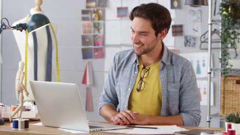 Male-Business-Owner-Working-In-Fashion-Meeting-On-Video-Call-Using-Laptop