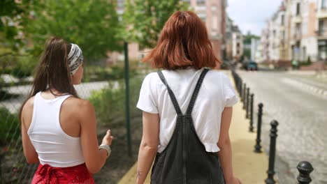 two women walking on a city street