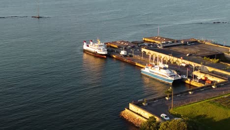 stunning aerial view of tallinn harbor showcasing docked boats and calm waters illuminated by the golden hues of sunset, capturing the serene beauty of the coastal area