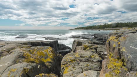 time lapse: waves crashing against rocky shoreline