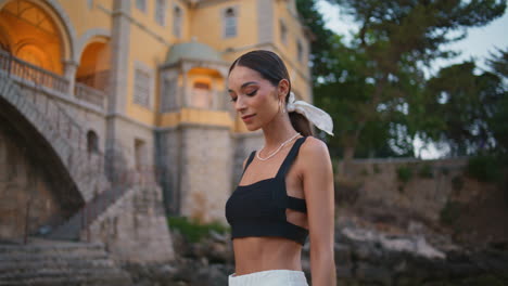 woman in fashionable outfit in front of beautiful building