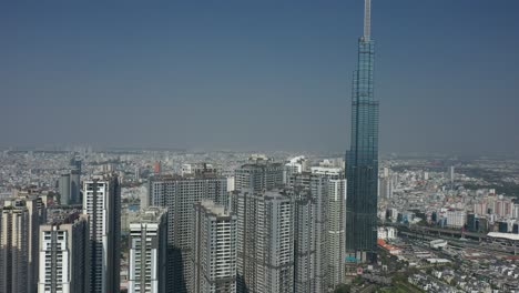 Aerial-view-of-Landmark-Central-Park,-Saigon-River-and-Ho-Chi-Minh-City-Skyline,-Vietnam-on-a-sunny-day