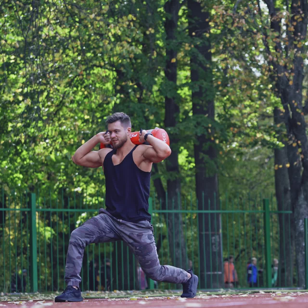 . Man training at stadium. Fit athlete doing exercises at stadium