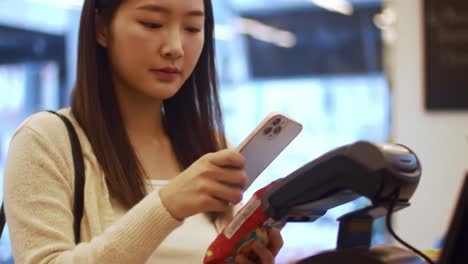 a young woman engages in a checkout experience while scanning snacks at a retail counter, representing modern consumer habits and everyday transactions