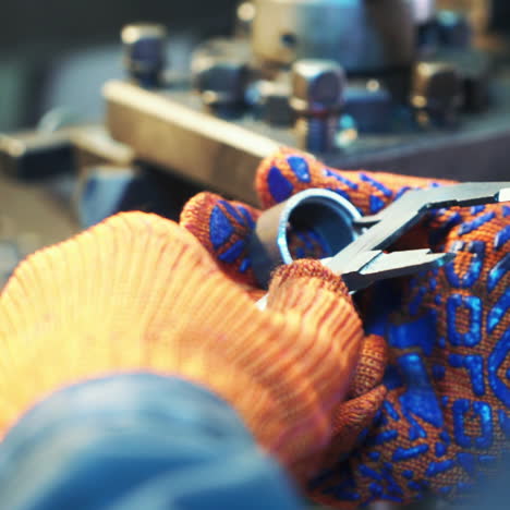 worker professionally measuring the shaped material on lathe