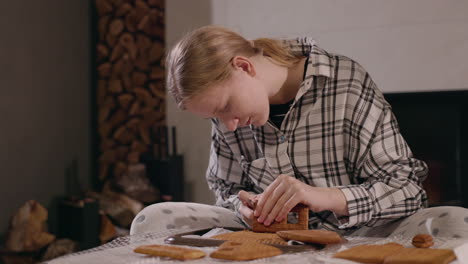 woman making a gingerbread house