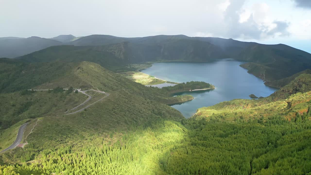 푸른 언덕 으로 둘러싸인 라고아 도 푸고, 부분적 으로 구름 이 가득 한 하늘 아래, 공중 에서 볼 수 있는 모습