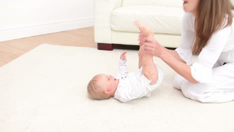 woman playing with a baby on the carpet