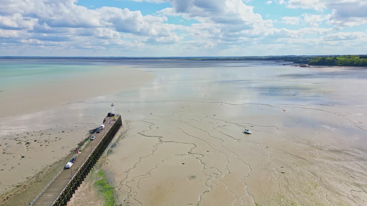 Cale de la Fenetre pier and beach during low tide, Brittany in France