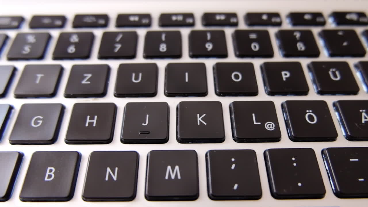 Close up of a black laptop keyboard in daylight