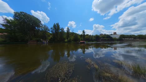 serene river landscape with boats and city in background