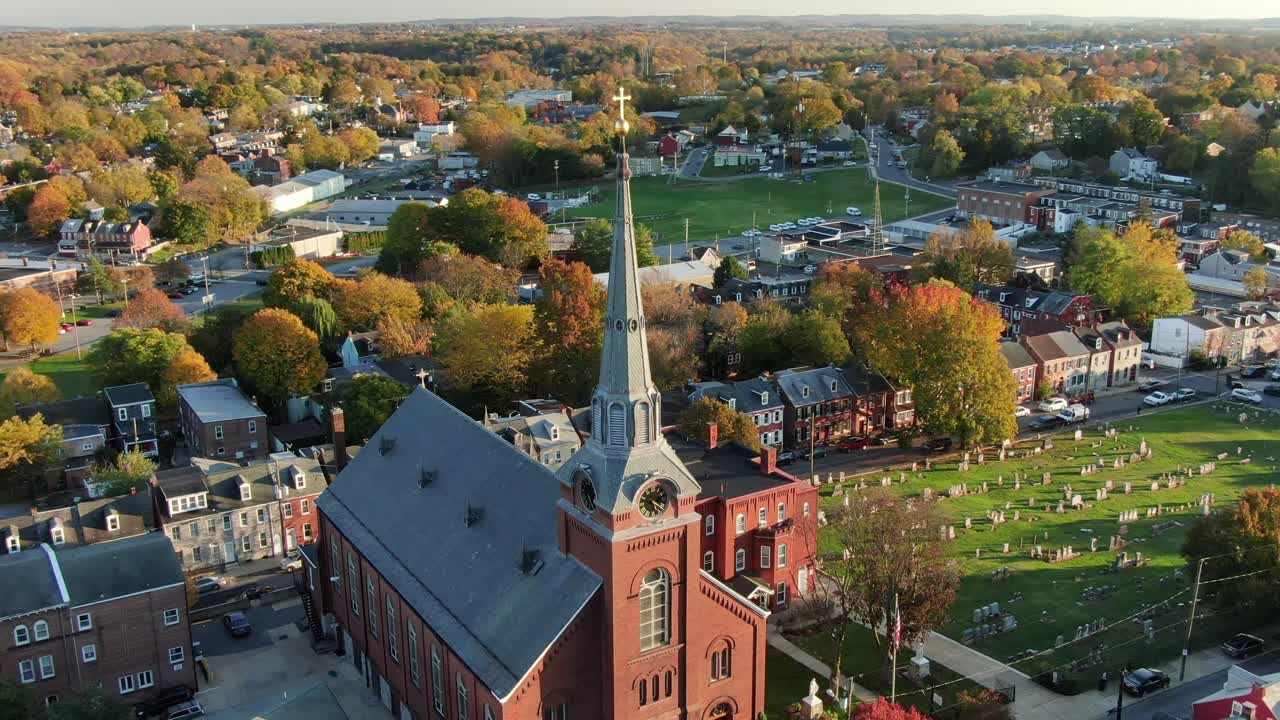 American religion, Methodist, Protestant, Lutheran, Catholic church cathedral urban city setting during dramatic sunlight, aerial orbiting shot around steeple, separation of church and state