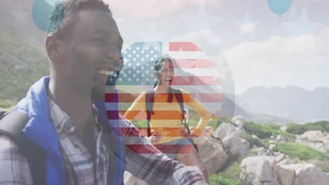 Animation-of-american-flag-over-smiling-diverse-couple-hiking-in-mountains