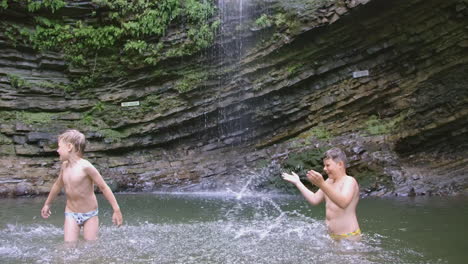 kids playing in a waterfall pool