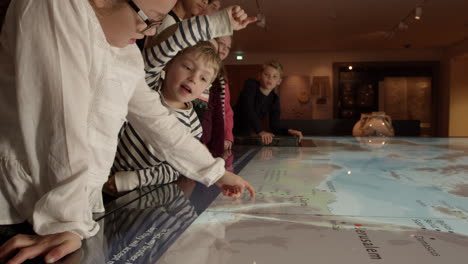 pupils on school trip to museum looking at map shot on r3d