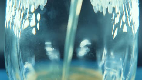 a macro shot of a filling glass with orange juice, studio lighting, 120 fps slow motion, full hd