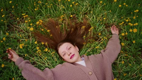teenage girl relaxing in a field of dandelions