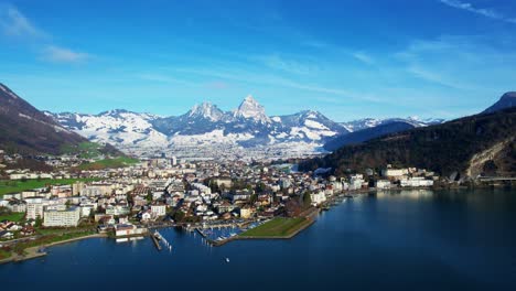 the city is surrounded by mountains, and the lake is a beautiful blue color