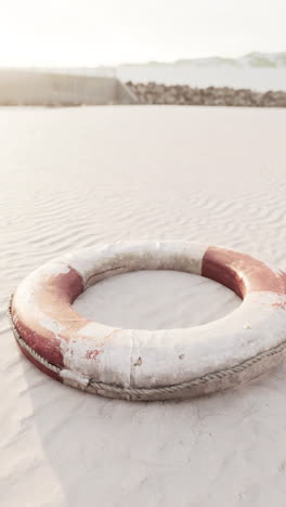 old life buoy on sandy beach