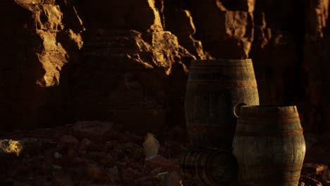 old wooden vintage wine barrels near stone wall in canyon