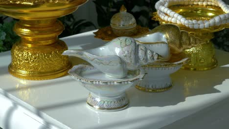 Close-up-of-traditional-Thai-ceramic-and-gold-tableware-and-ornaments