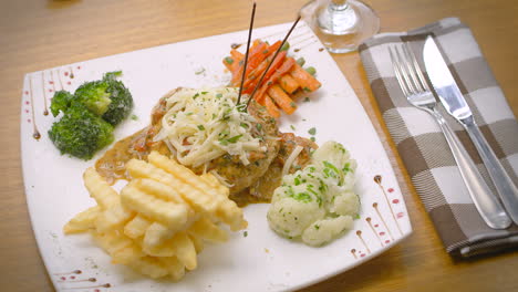 mustard chicken with french fries, salad, and grated cheese, mediterranean