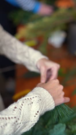 hands making a christmas wreath