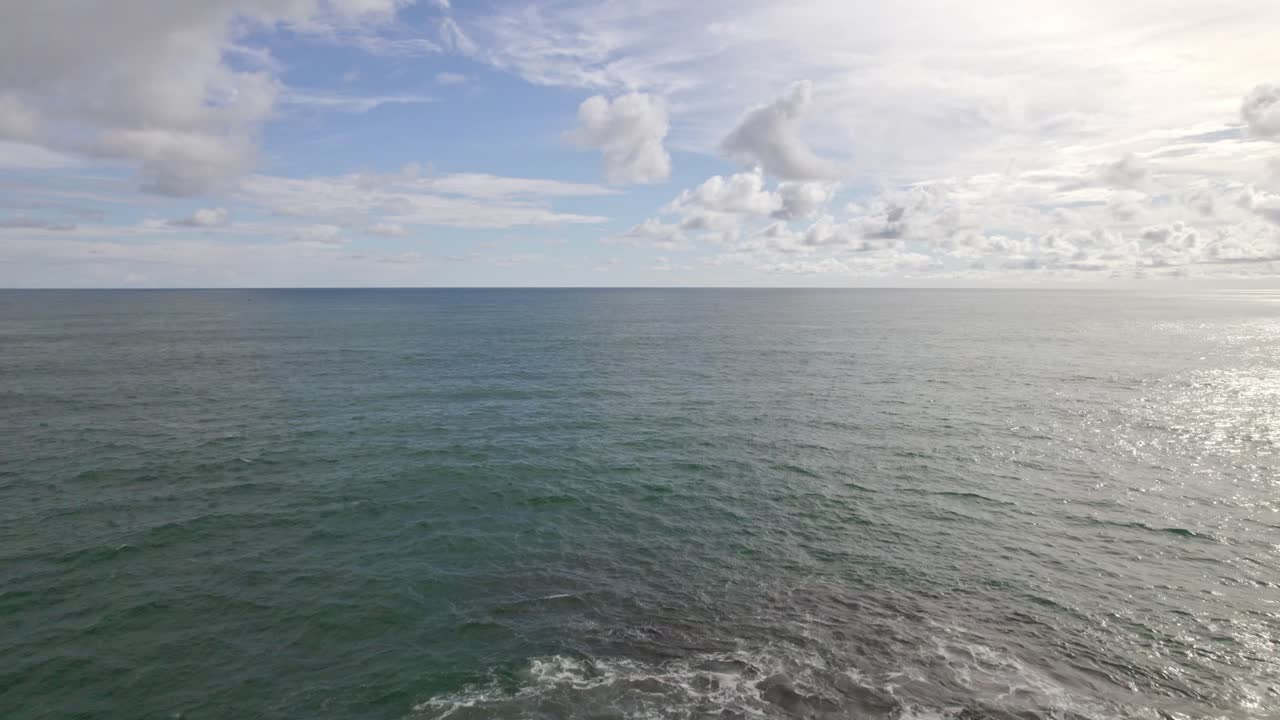 Aerial dolly in flying over rugged sea shore on a cloudy day in Dominicalito Beach, Costa Rica
