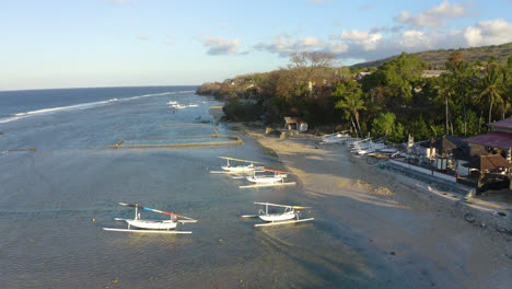 forwarding drone to capture traditional balinese fisherman boat preparing to sail in indian ocean