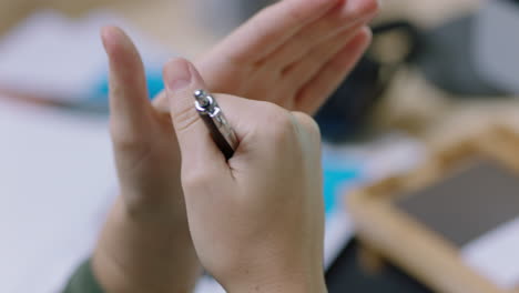 business-woman-brainstorming-hands-holding-pen-talking-to-colleagues-in-boardroom-meeting-sharing-ideas-collaborating-in-office-close-up