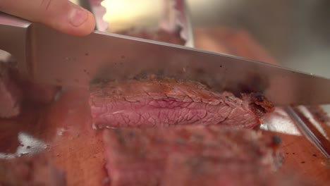 chef cutting juicy medium rare flank beef, slow motion