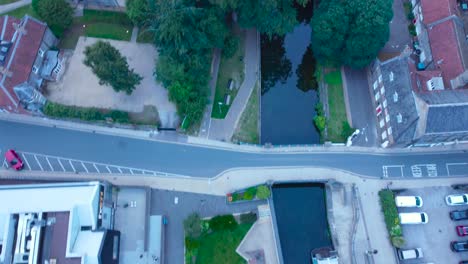 Aerial-Drone-Footage-Looking-Down-at-Little-Ouse-River-and-Revealing-Historical-Thetford-Priory-in-Norfolk,-England