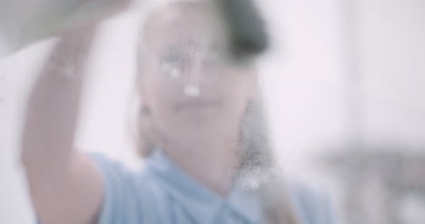 cleaning woman cleaning window with detergents 9