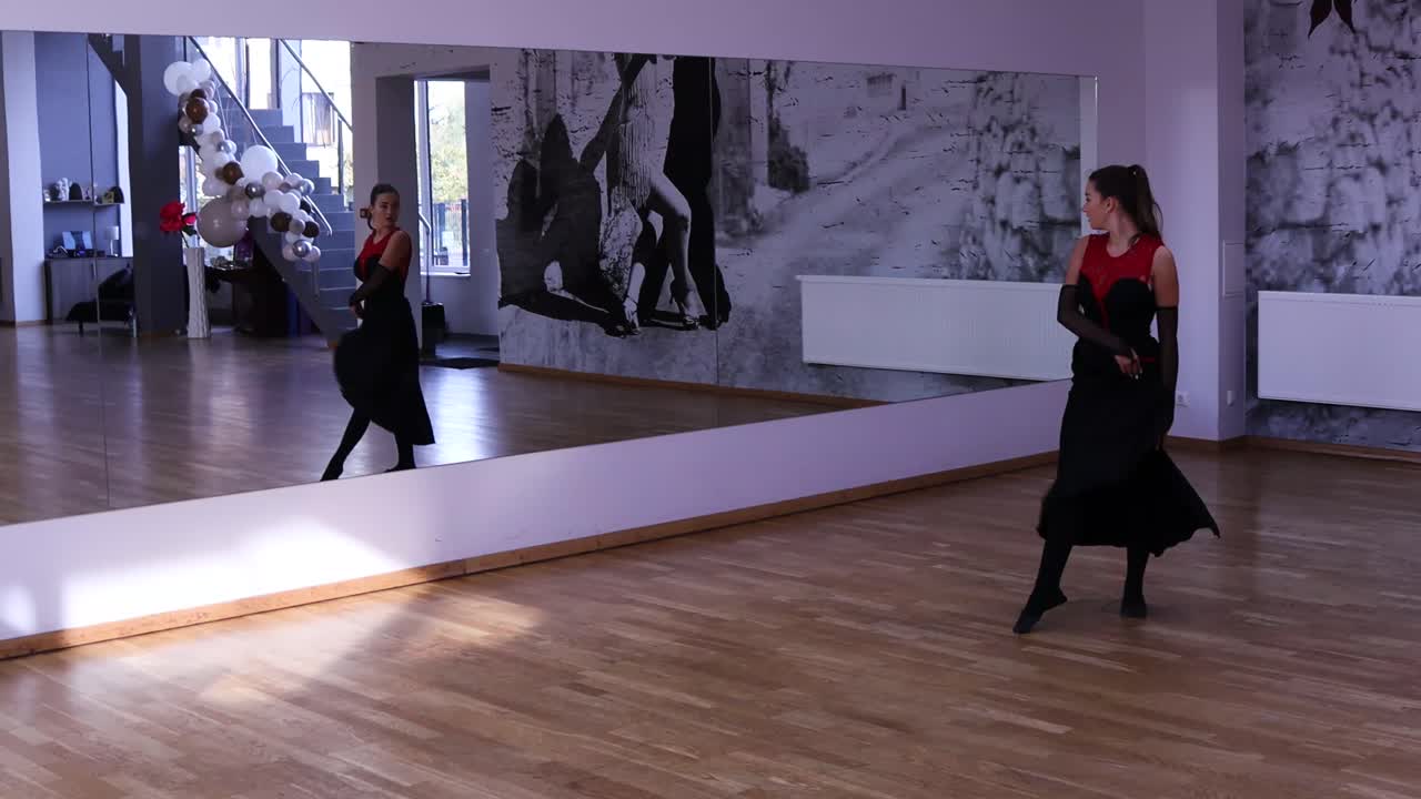 Female dancer dancing in front of the mirror
