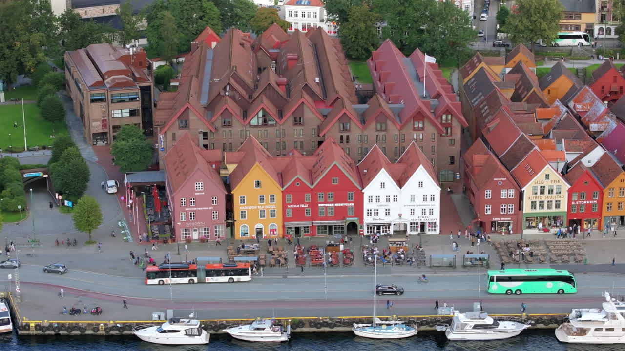 Drone gliding along Bryggen in Bergen, Norway, emphasizing the iconic row of wooden Hanseatic buildings
