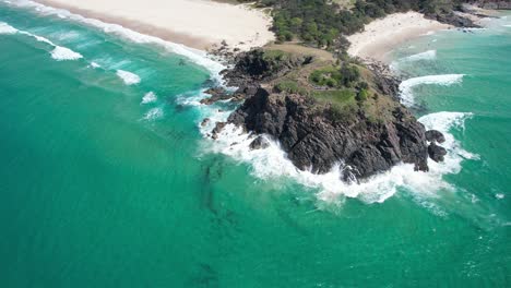 ocean waves splashing at norries headland in new south wales, australia - aerial drone shot