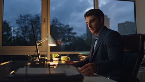 tired man working office late alone. corporate manager suffering eyes strain