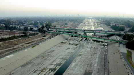 aerial view of los angeles river channel with freeway traffic