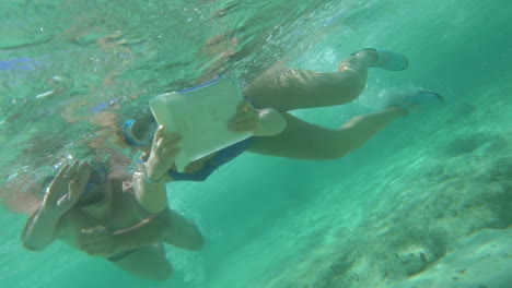 people using touch pad underwater