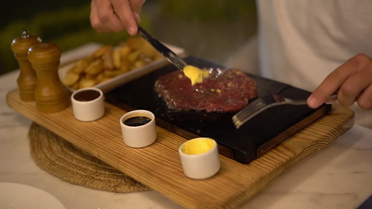 A Chief cooks food on a grill, close up shot, insert shot