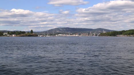 View-of-Oslo,-Norway-on-sunny-summer-day-from-moving-boat