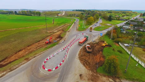 Cargo-trucks-moving-on-country-road.-View-from-above.-suburban-road-construction