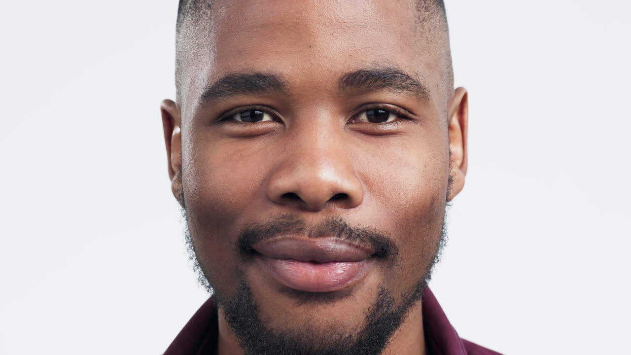 Happy, smile and face of a black man in a studio